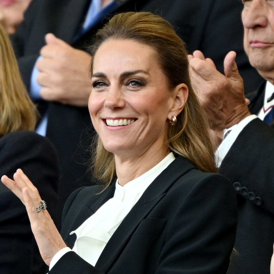 Kate Middleton attends the women's rugby wearing a black suit and ruffled white shirt